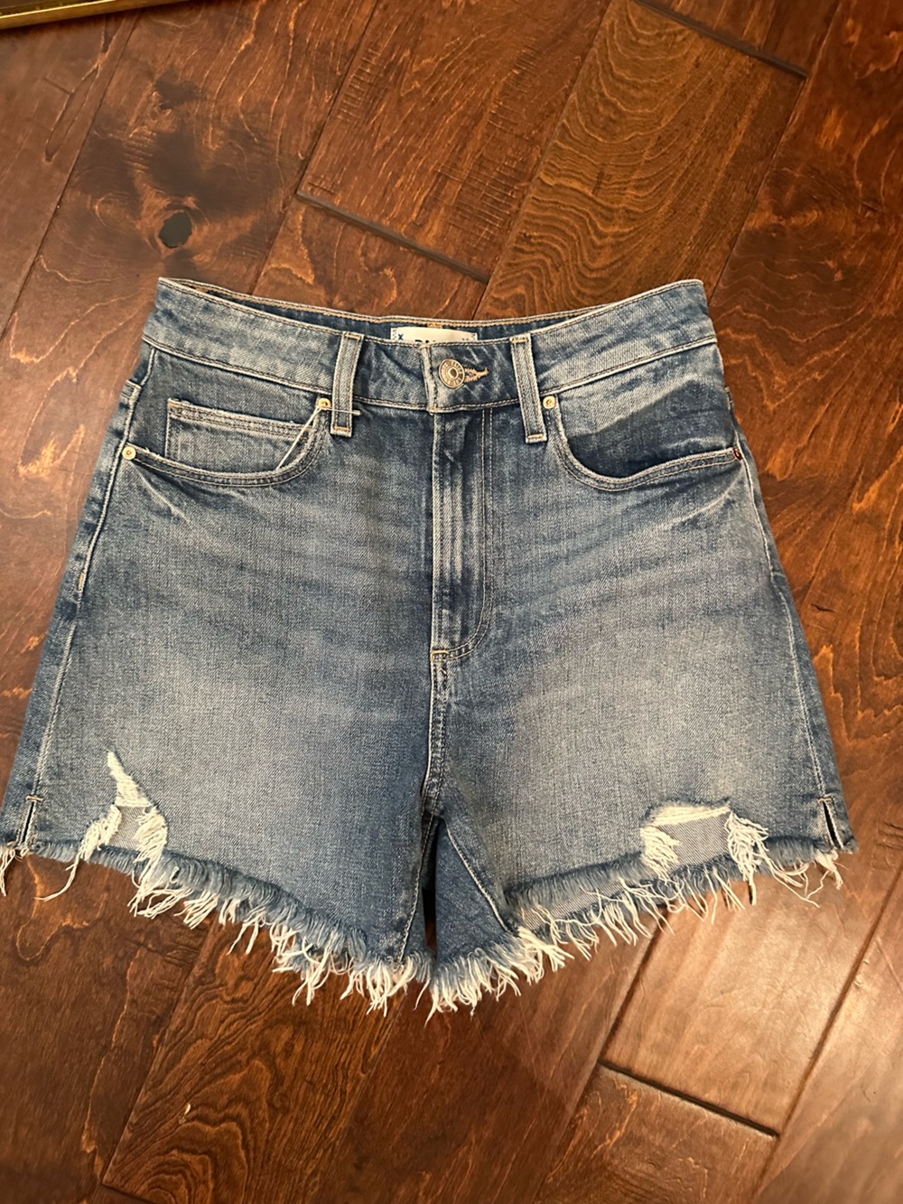 PAIGE Distressed Light Blue Denim Cutoff Shorts